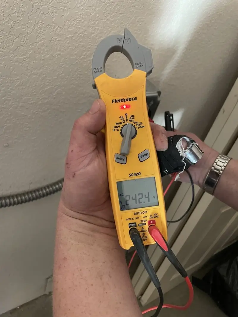 Voltage testing with clamp meter during Ceiling Fan Installation in Kirby